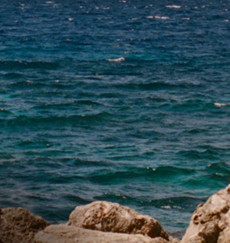Rocky coastline with blue ocean backdrop 