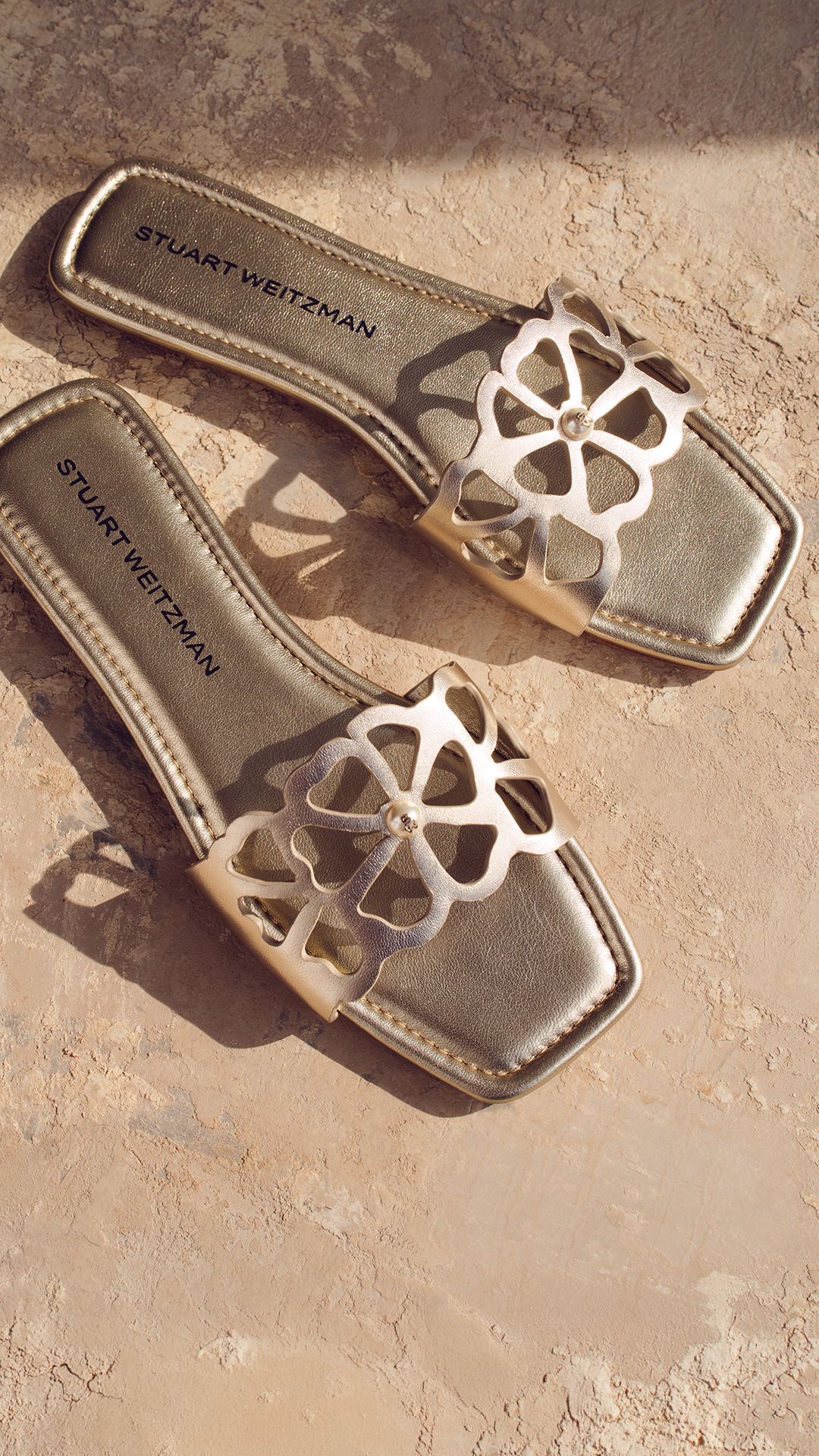Stuart Weitzman Jasmine slide sandals in gold metallic leather with floral cutout upper 